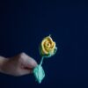 Crochet closed rose PDF pattern with free video tutorial showcasing step-by-step instructions for crafting a beautiful crochet rose.