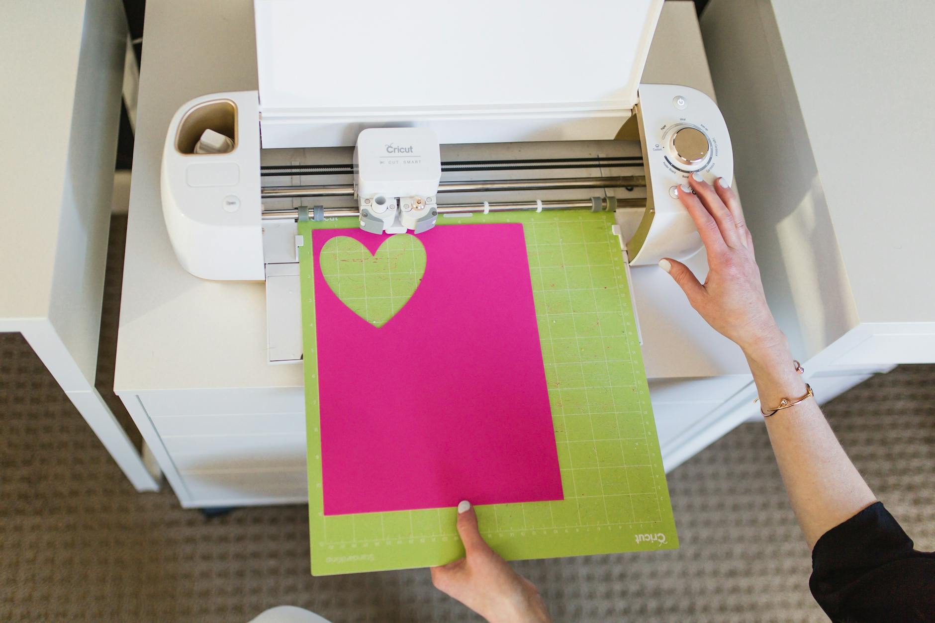 Hands downloading free Cricut SVG files for crafting projects